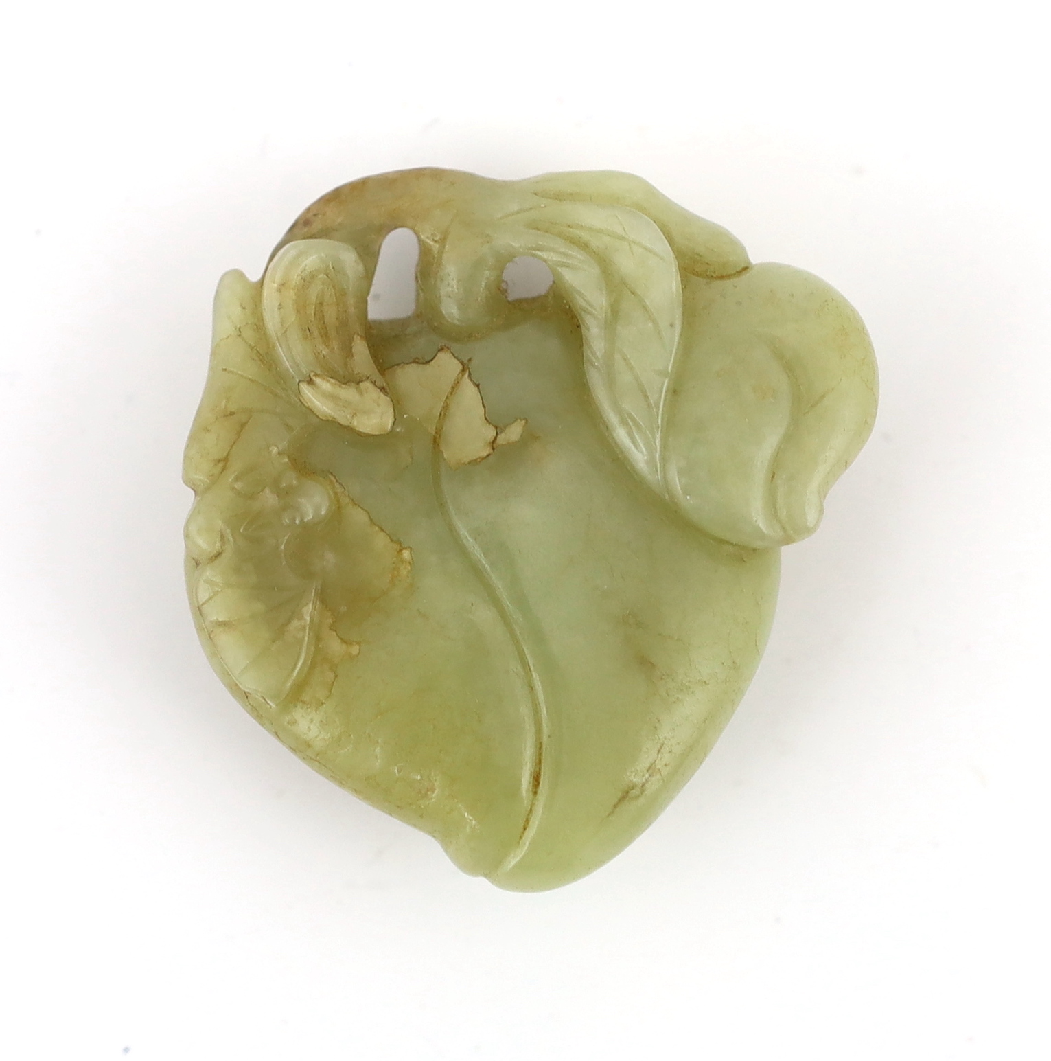 A Chinese pale celadon and russet jade carving of peaches and two bats, 17th century, the stone with pale russet and brown inclusions, 5.9cm. Condition - natural discolouration and flaws within the jade but otherwise goo